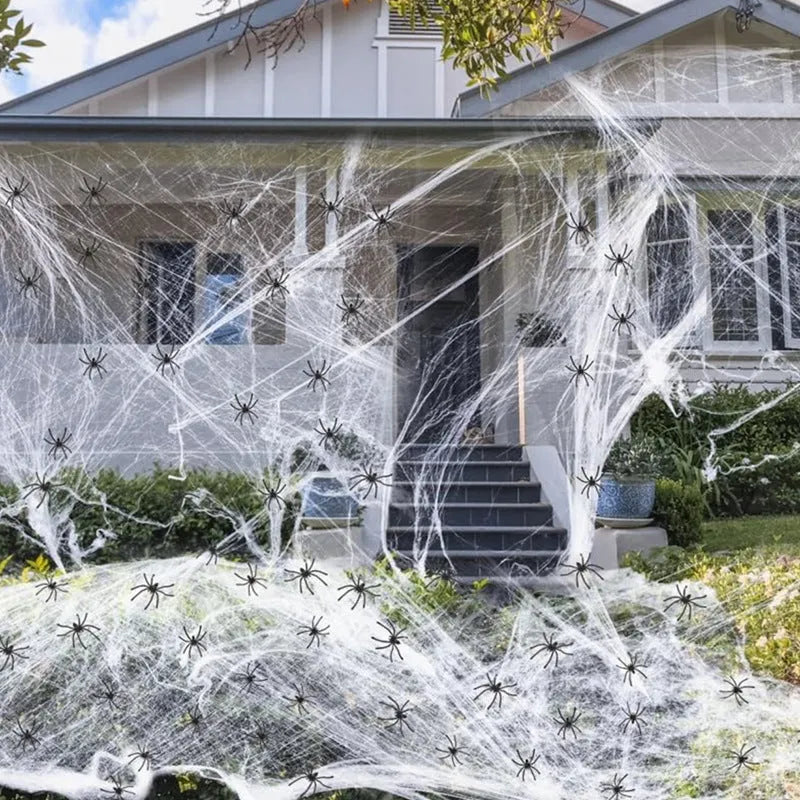 White cotton spider Halloween decoration web with plastic spiders draped across furniture