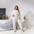 Women's creamy white polyester two-piece suit set with plush crew neck top and trousers