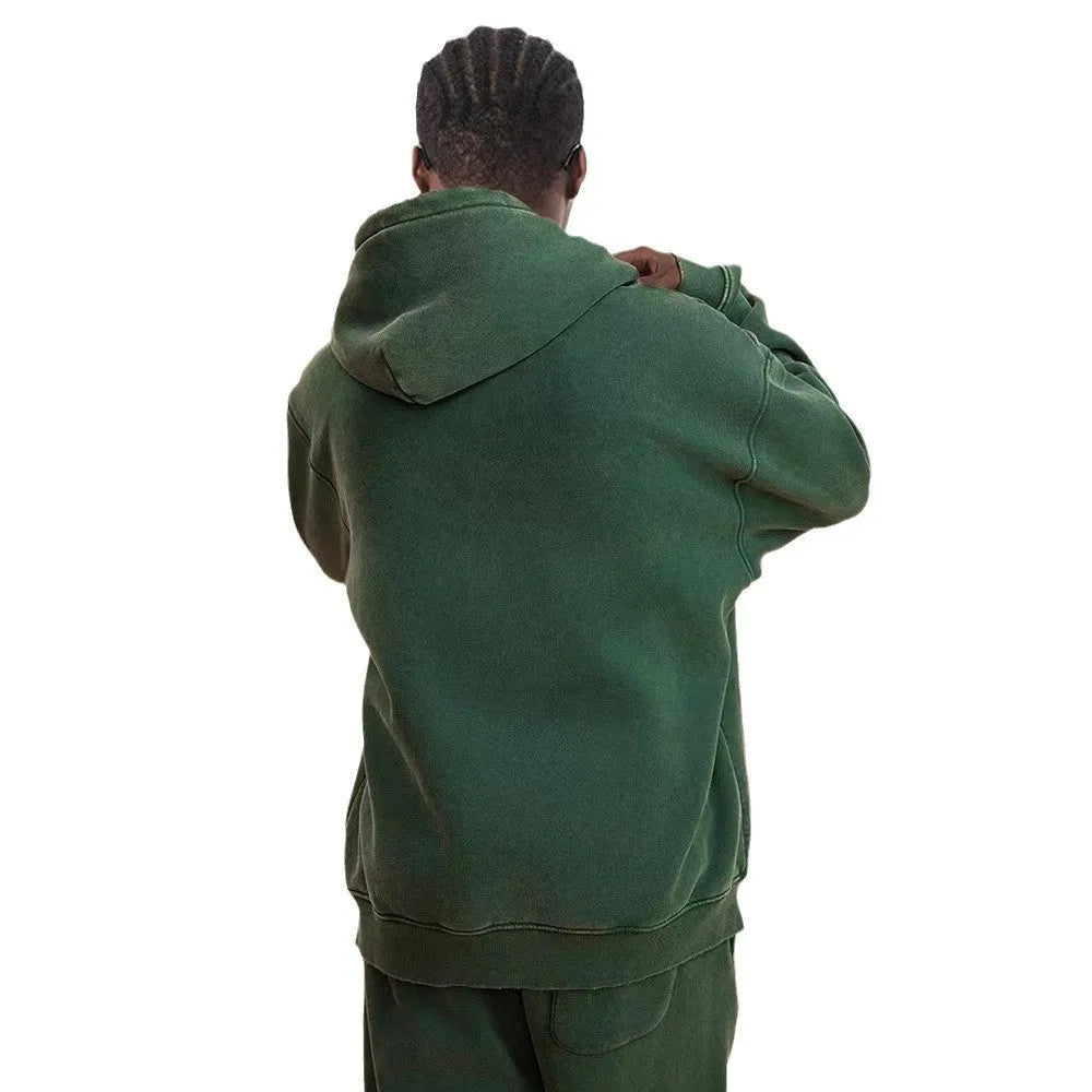 Man wearing a washed black fleece-lined hooded cardigan with a double zipper front.