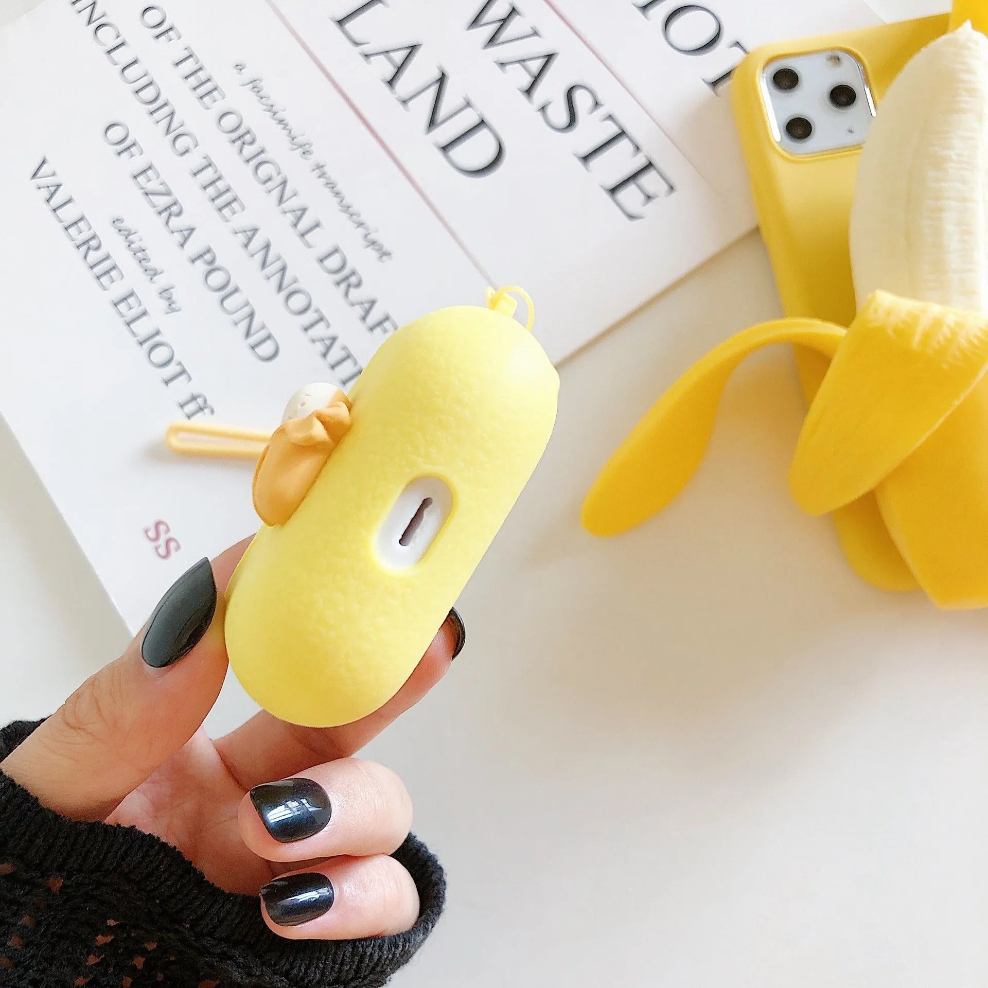 Squeeze the banana graphic on an open banana coloured IMD back cover case for iPhone.