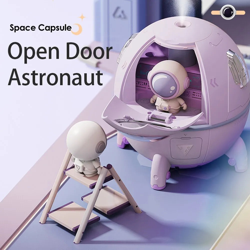 Purple astronaut-shaped USB desktop humidifier with LED lights on a desk