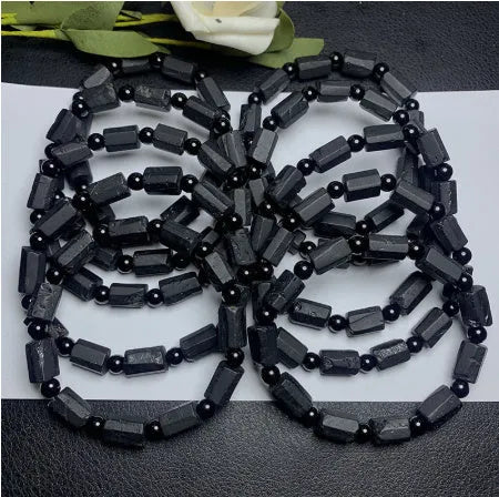 Natural black tourmaline rough stone bracelet with 10mm beads showing textured stone surfaces