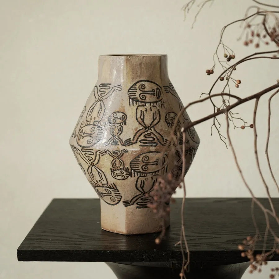Hand-painted ceramic vase with tribal totem patterns in cylindrical shape