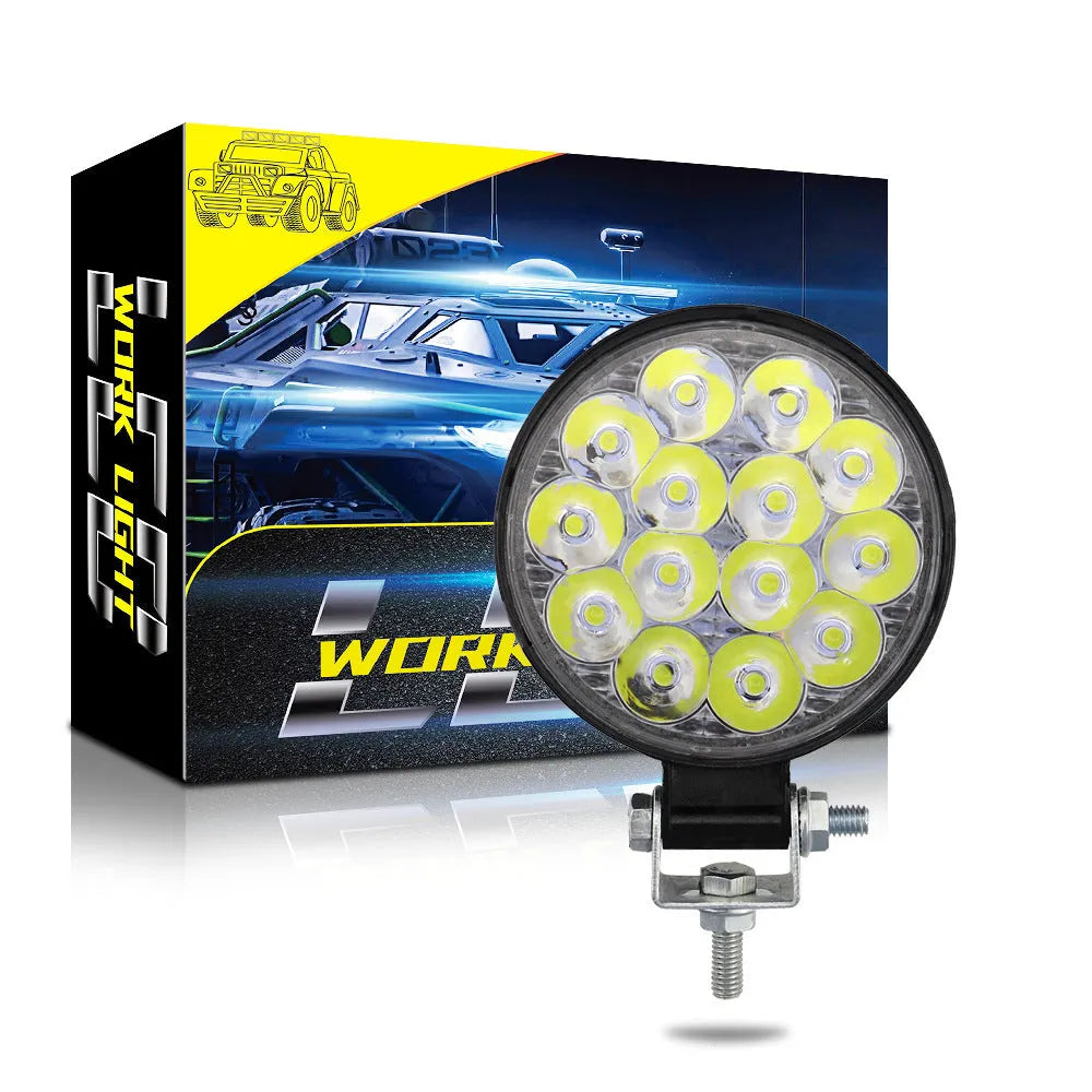 Compact round 42W LED work light with aluminium housing for car, truck, or motorcycle.