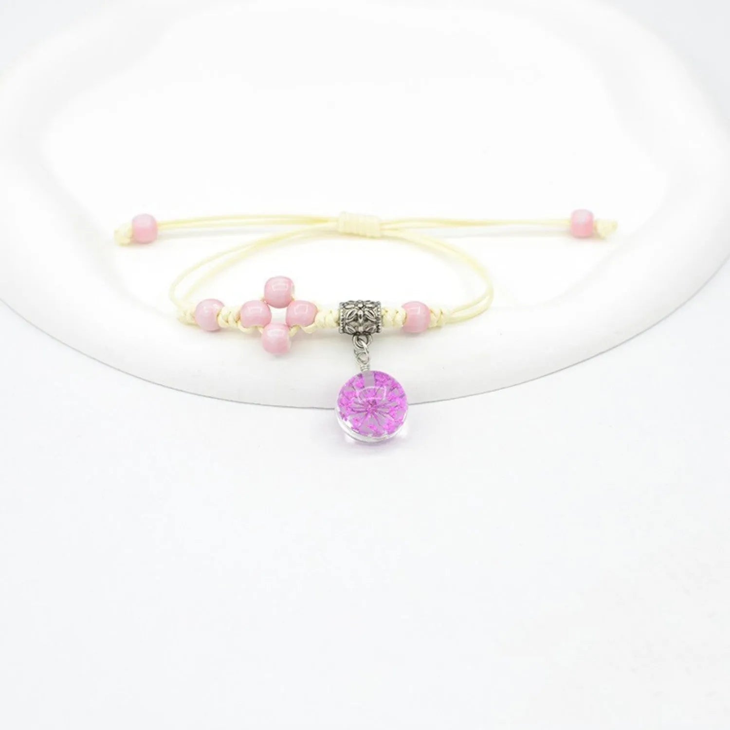 Women's hand-woven glass bracelet with large 1.4cm beads containing dried flowers, shown in blue colour option