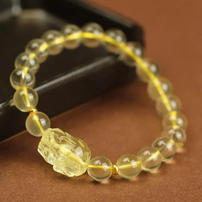 Yellow leather bracelet with a clear artificial crystal Pi Xiu charm in Chinese national style.