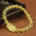 Yellow leather bracelet with a clear artificial crystal Pi Xiu charm in Chinese national style.