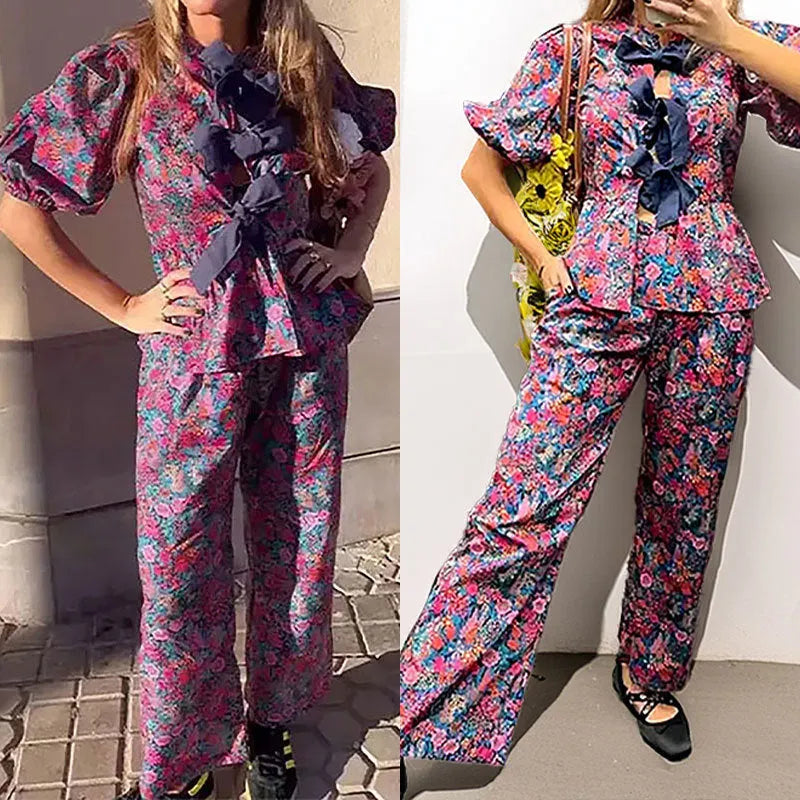 Floral print trousers suit with tie-neck top and puff sleeves, matching two-piece set