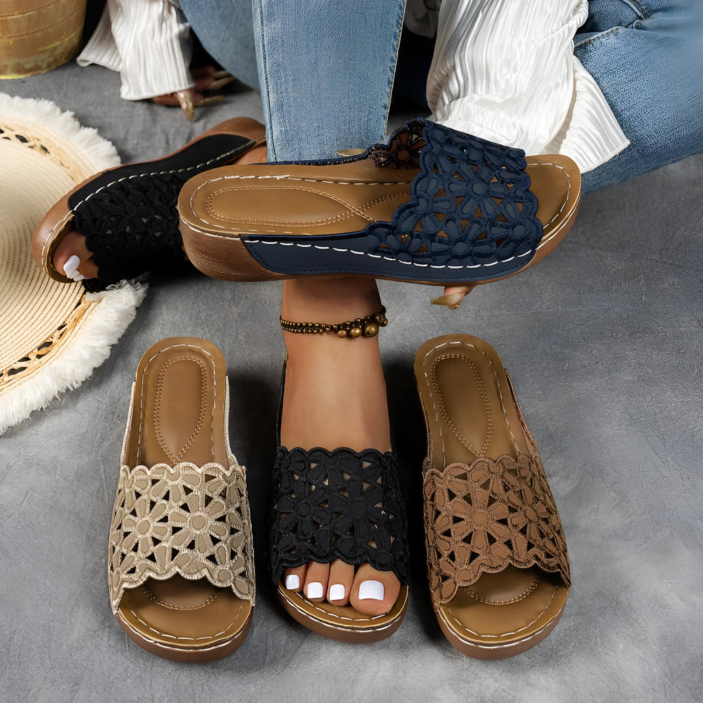 Women's floral cutout wedge beach slippers in black, blue, khaki, or light brown with PVC upper and rubber sole