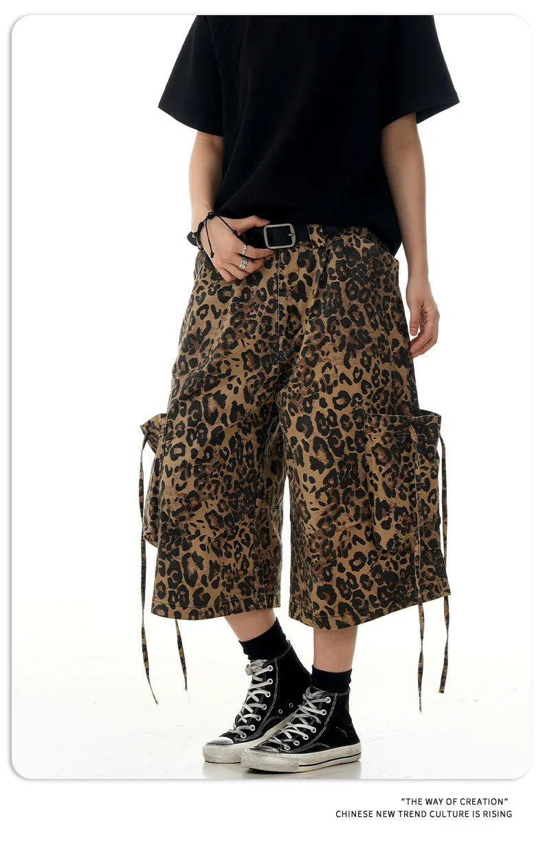 Leopard print cotton cropped trousers with a high waist and straight leg on a hanger