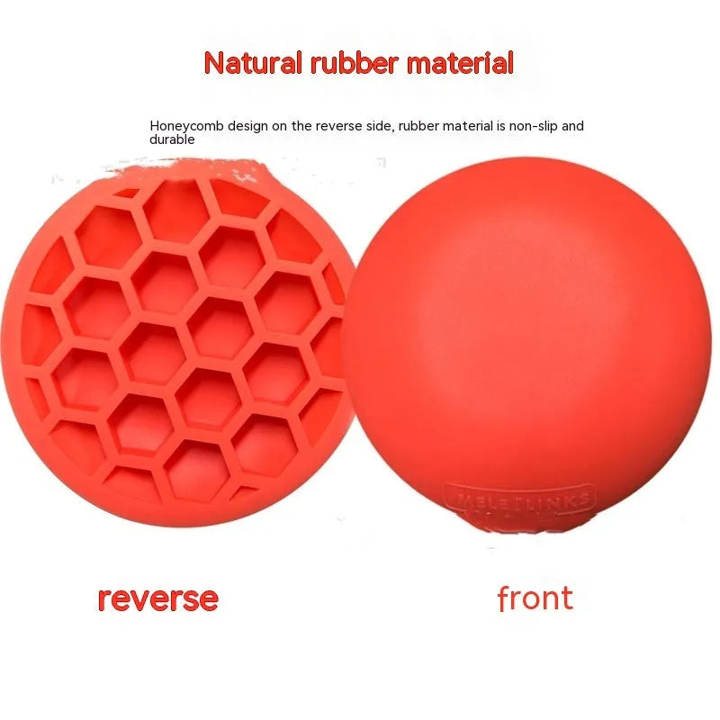 Orange golf training mat with rubber centre disc on practice surface