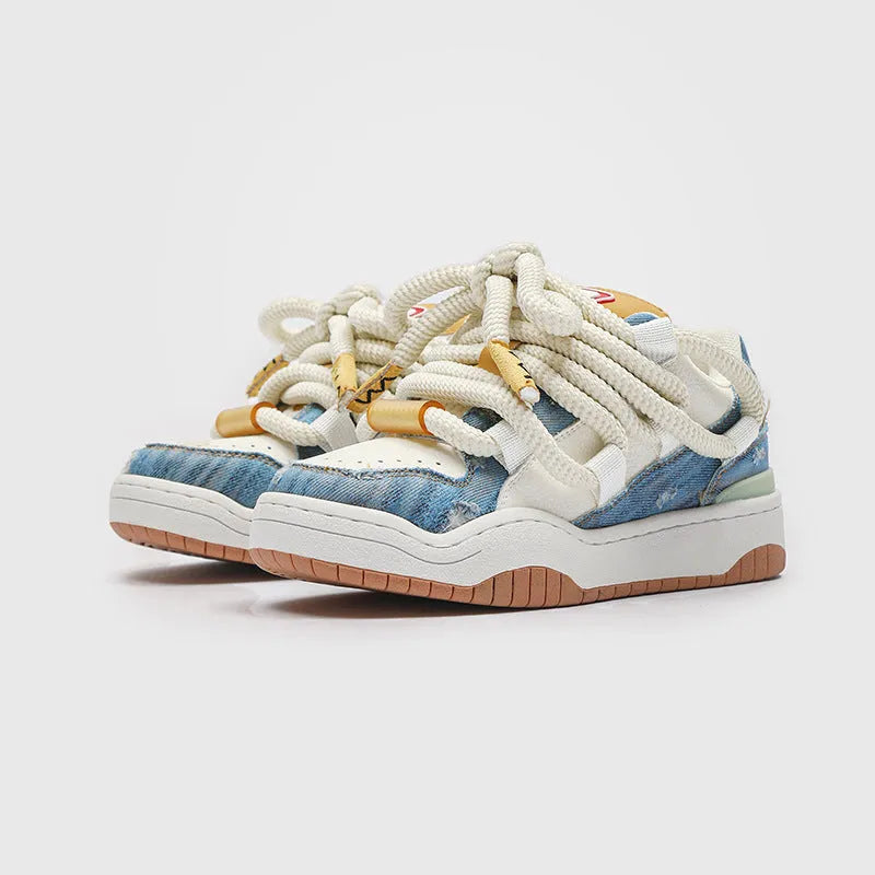 Low-top lace-up casual sneakers in denim blue with a round toe and thick rubber sole.
