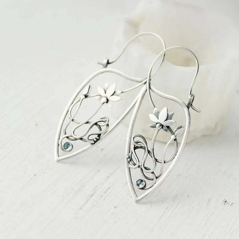 Silver lotus vine rhinestone earrings with geometric floral design