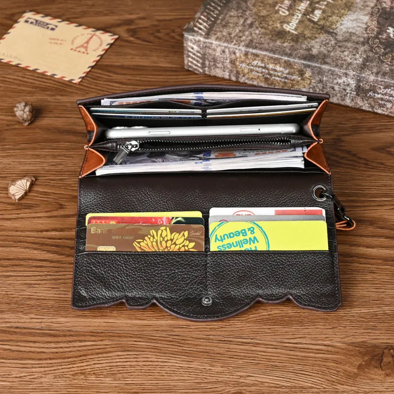 Women's brown tri-fold leather wallet with embossed floral pattern showing interior card slots