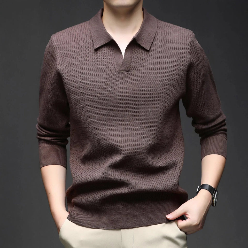 Men's loose green pullover sweater for casual autumn wear on a hanger