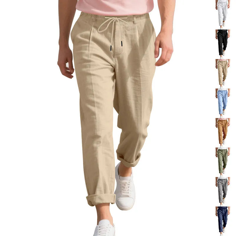 Men's loose-fit linen trousers in light khaki colour with a drawstring waistband.