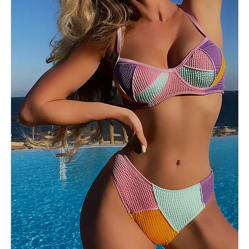 Women's spliced colour bikini set with steel push-up cups and matching shorts.