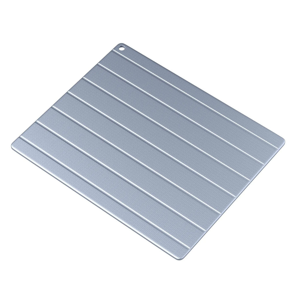 Household aluminium quick defrosting plate device on a kitchen countertop.