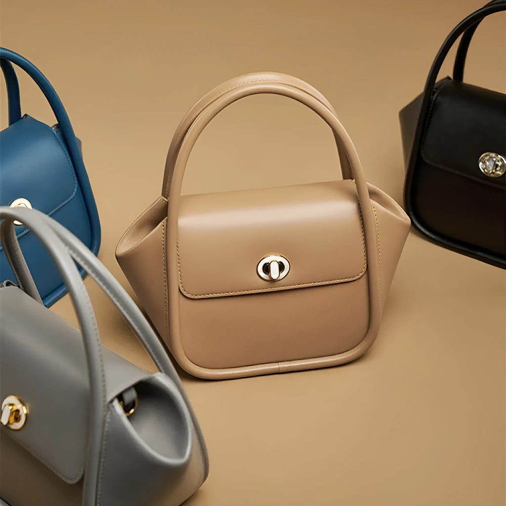 Women's leather cross-body wing bag with buckle closure in four colour options
