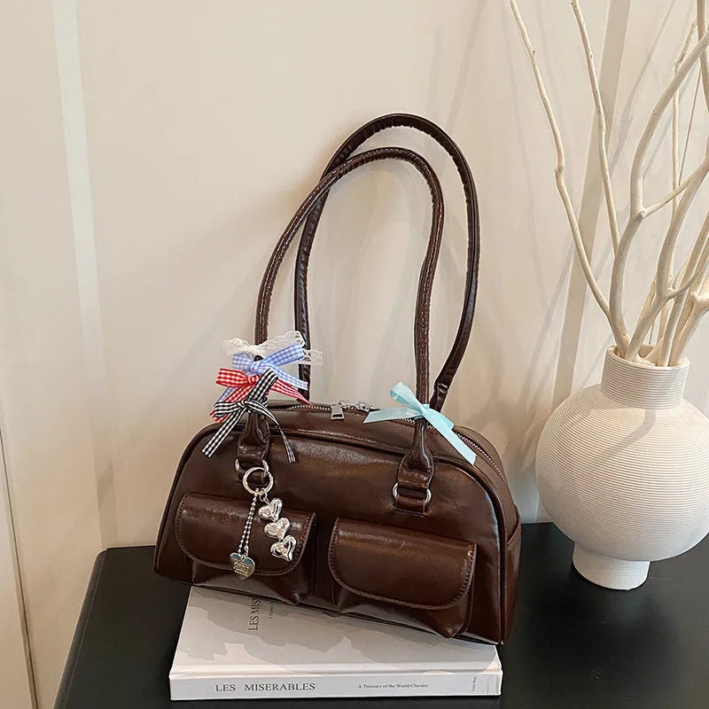 Retro one shoulder underarm pillow bag in PU leather with flap closure and double strap in black brown or red colour options