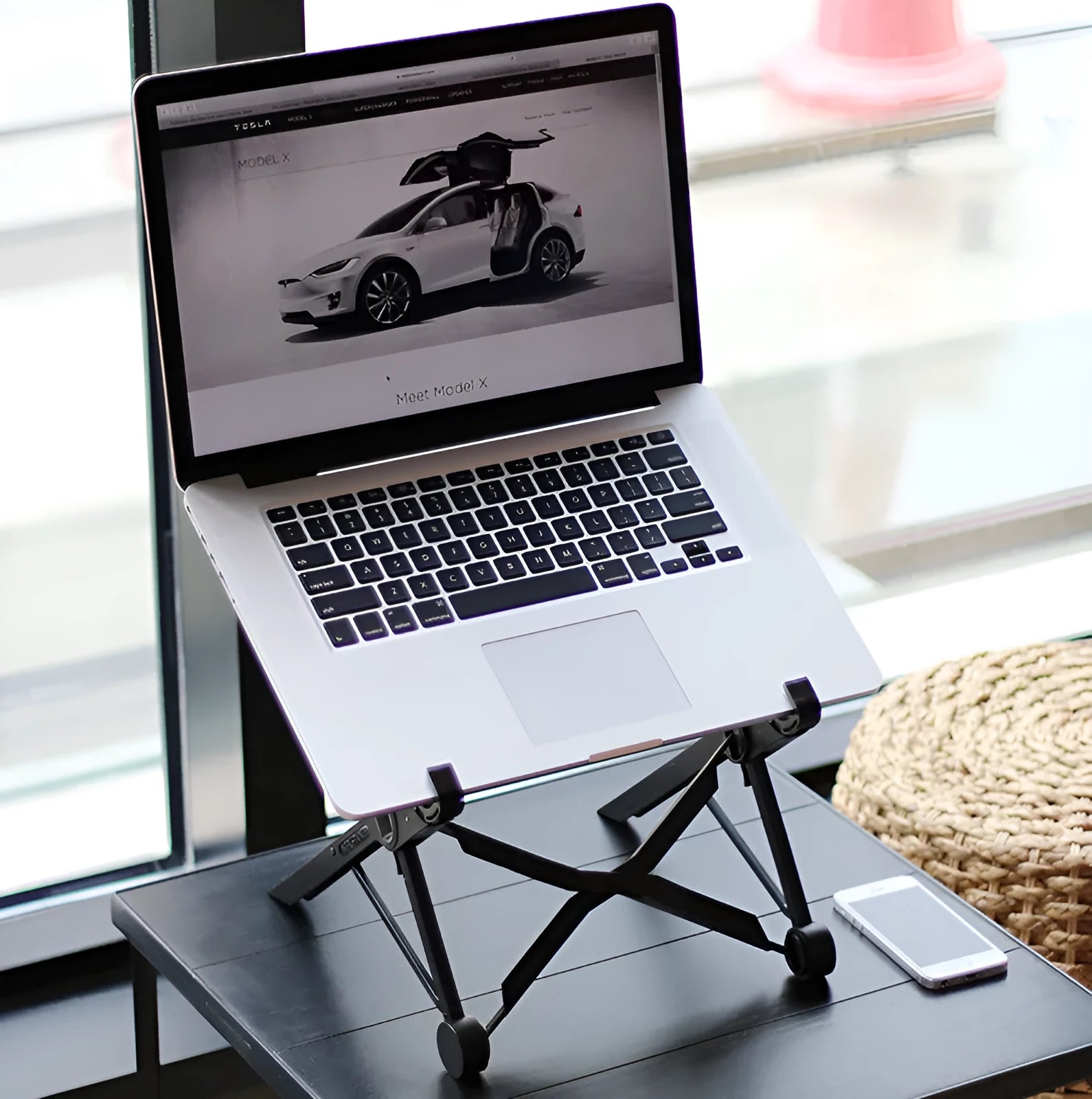 Black folding portable laptop stand made from reinforced nylon, shown in open and closed positions