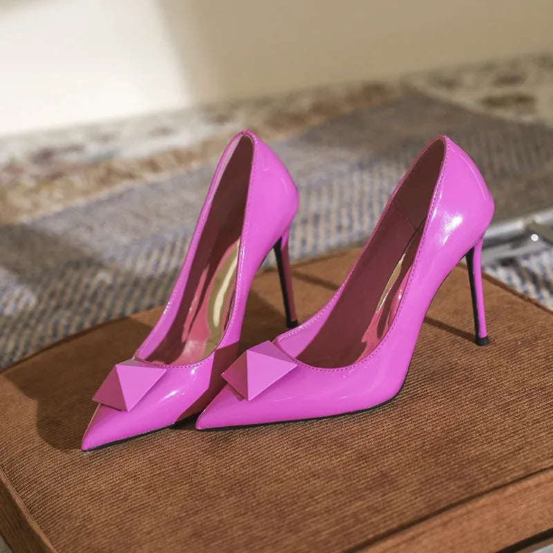 Women's pink patent leather stiletto heels with pointed toe and buckle fastening