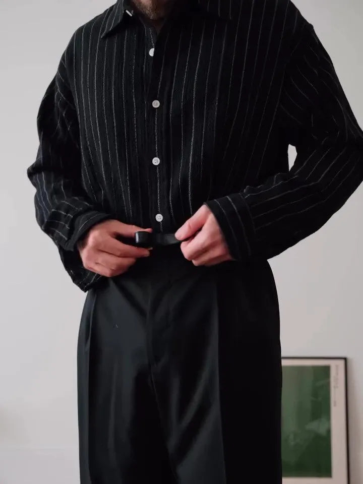 Black pinstriped polyester button-down shirt on a hanger showing regular fit