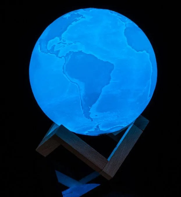 3D printed moon light lamp on wooden stand with detailed lunar surface, showing touch ring at base.