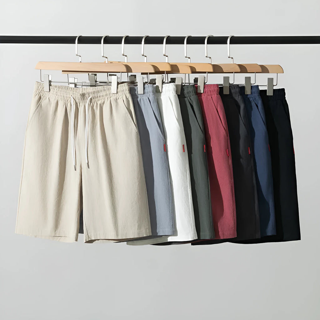 Man wearing solid colour cotton linen cropped trousers with a drawstring waist in a casual setting.