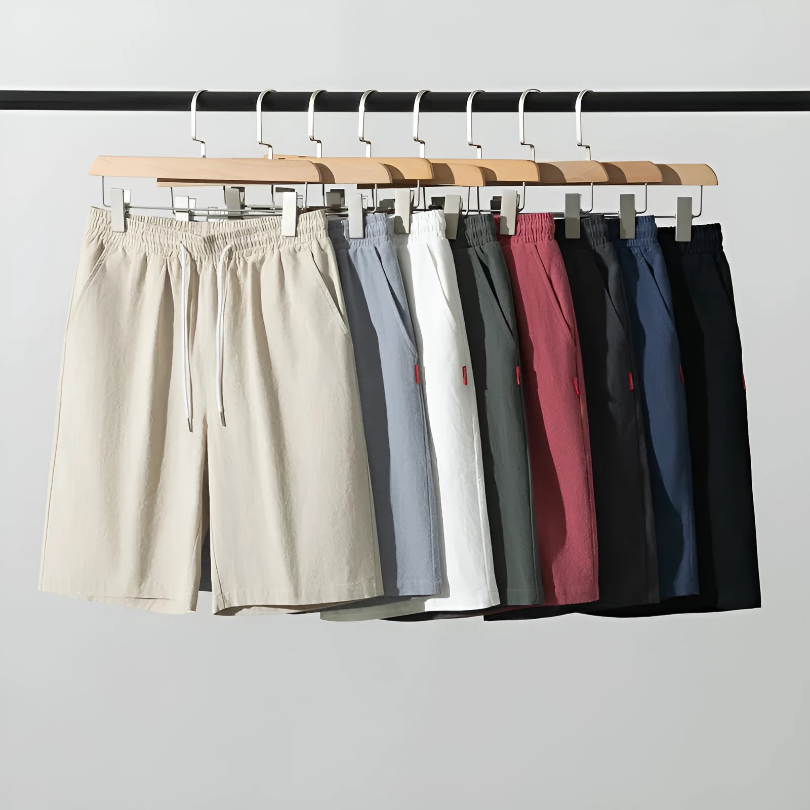 Man wearing solid colour cotton linen cropped trousers with a drawstring waist in a casual setting.