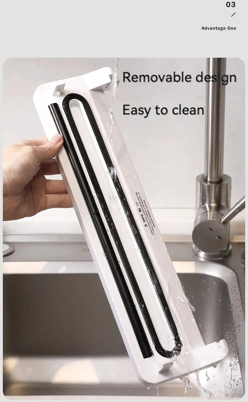 Small white automatic vacuum sealing machine for home food preservation on a kitchen counter.