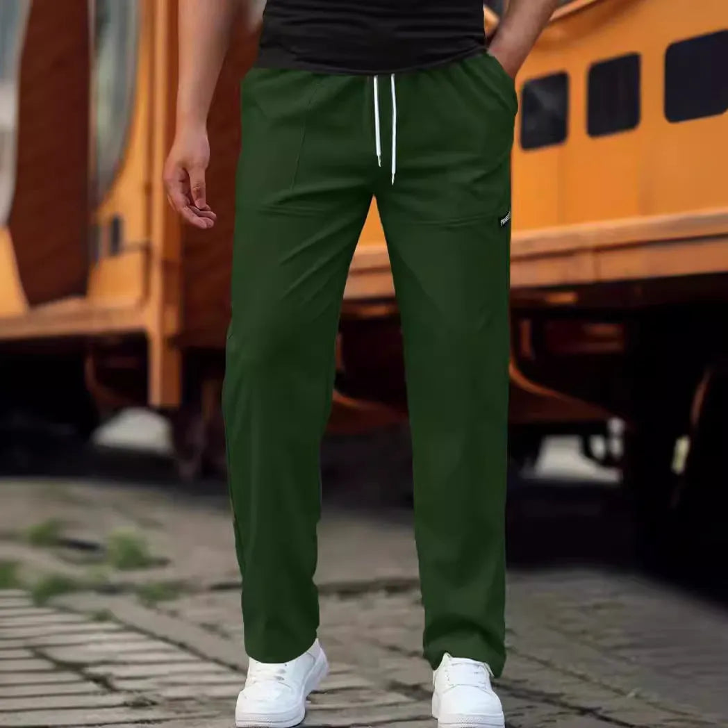 Men's polyester trousers in light grey colour, shown folded, for spring and autumn wear.