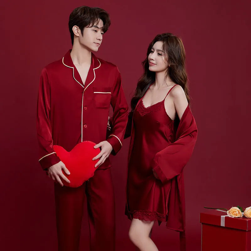 Red matching men's and women's silk sleepwear set with long sleeves and trousers.