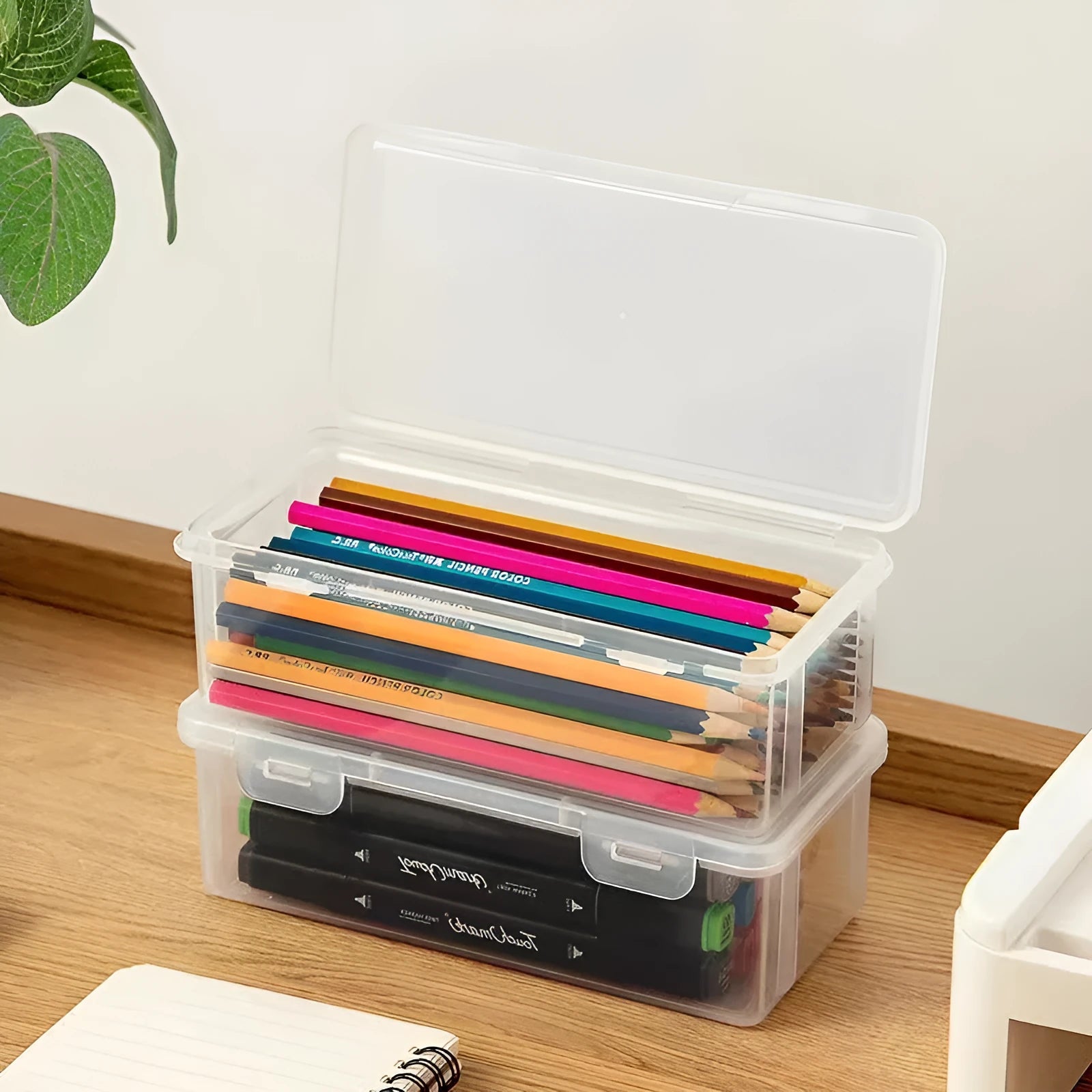 Transparent plastic pencil storage box showing interior capacity for organising drawing supplies