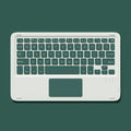 Pink Bluetooth touch keyboard and rechargeable mouse on a desk next to a tablet.