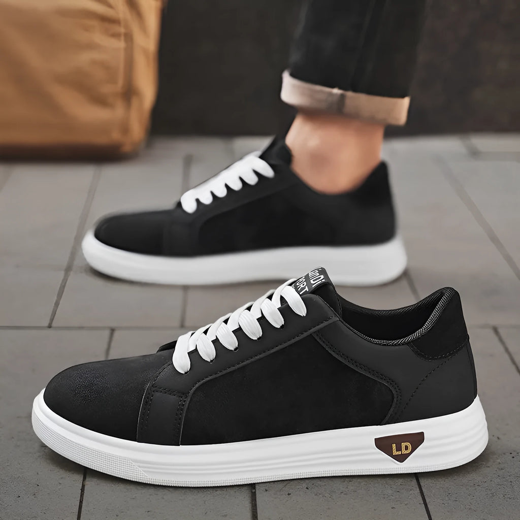Men's black snake pattern leather low-top sneakers with round toe and flat rubber sole.