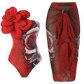 Women's blue floral print one-piece swimsuit with a matching gauze skirt overlay.