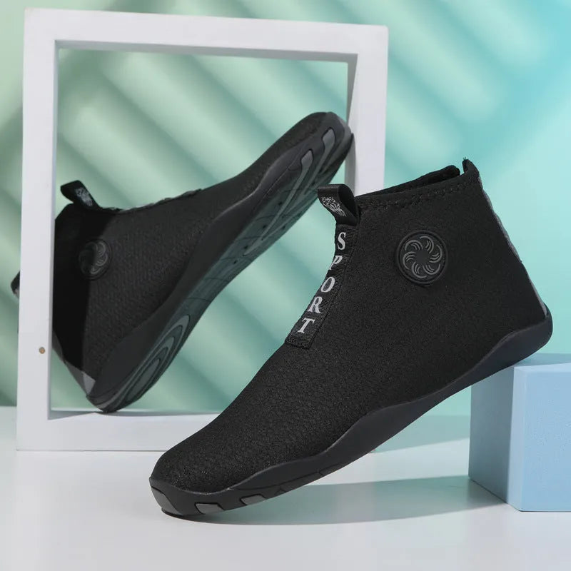 Casual mid-top outdoor beach shoes in black with coloured accents, showing mesh upper and rubber sole.