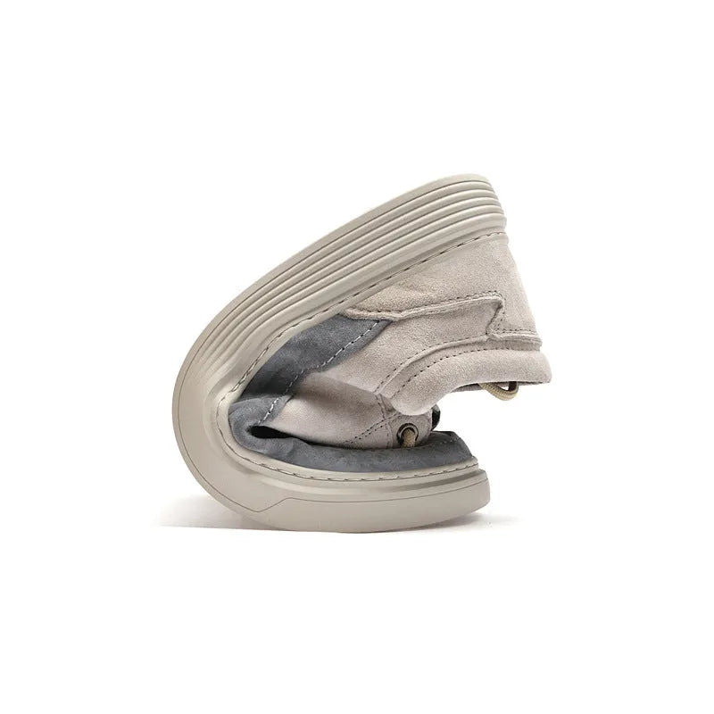 Grey and sand coloured low-top casual skate shoes with pigskin leather upper and rubber sole.