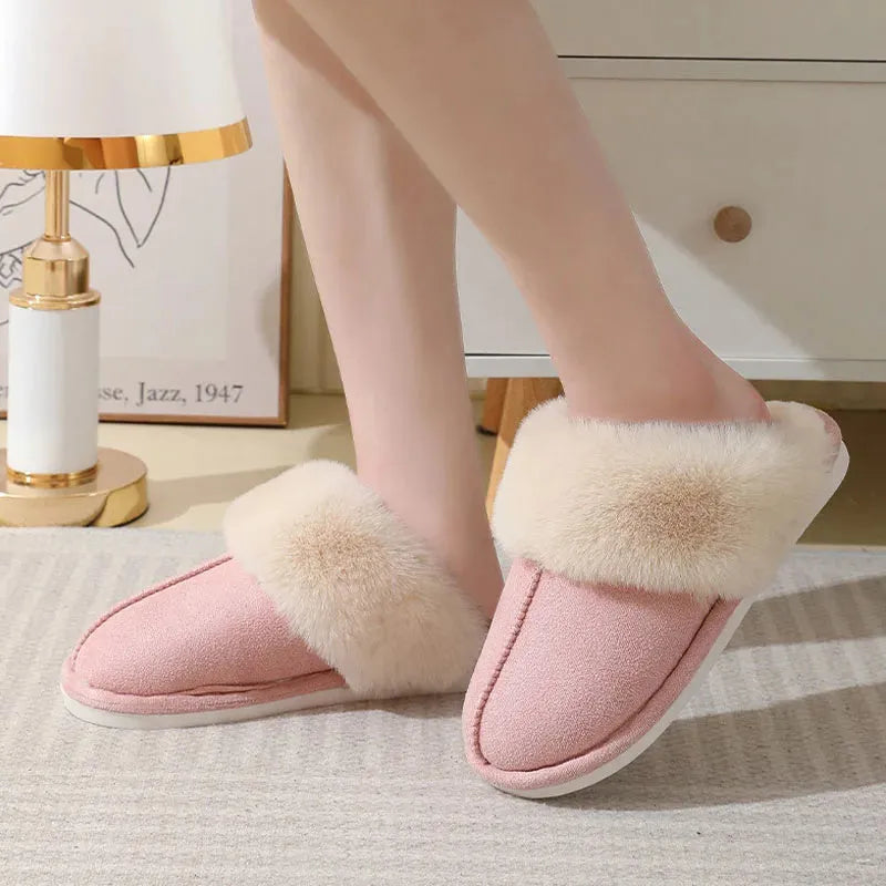 Women's plush winter slippers in pink with a round toe, flat heel, and anti-slip PVC sole.