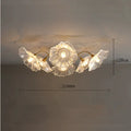 White flower pendant ceiling lamp with five flower heads emitting warm light in modern bedroom