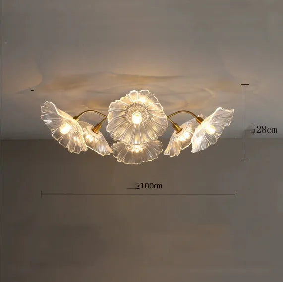 White flower pendant ceiling lamp with five flower heads emitting warm light in modern bedroom