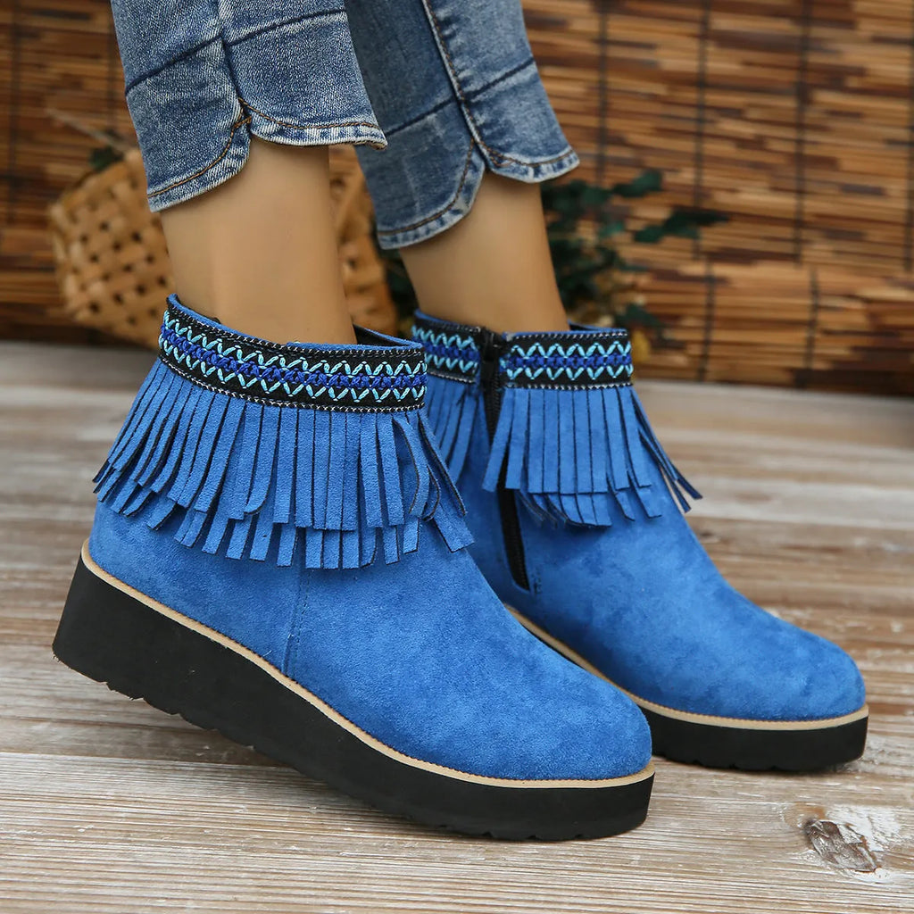 Women's black suede wedge ankle boot with side zip, tassel, and thick rubber sole.