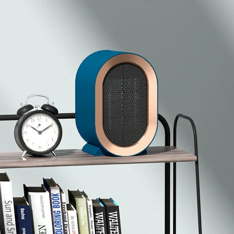 Compact desktop electric fan heater in black with mechanical control dial.