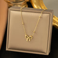 Gold electroplated bow necklace for women with titanium steel chain and adjustable length