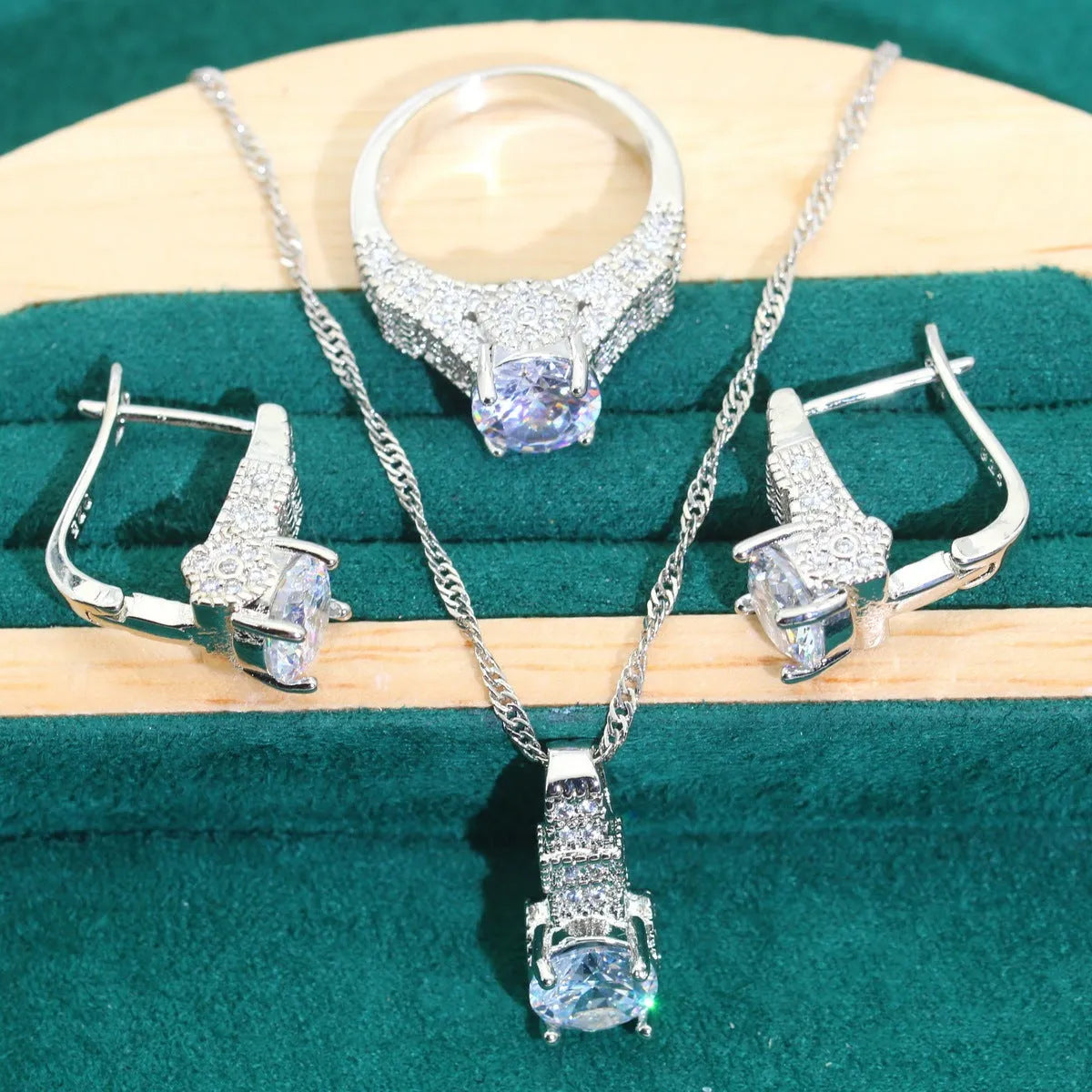 Bridal four-piece zircon jewellery set showing necklace, bracelet, earrings, and ring in alloy with water wave chain.