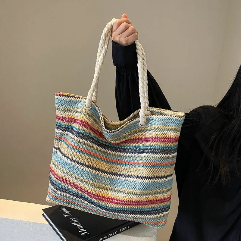 Blue nylon woven shoulder bag with large capacity and polyester lining shown against a neutral background