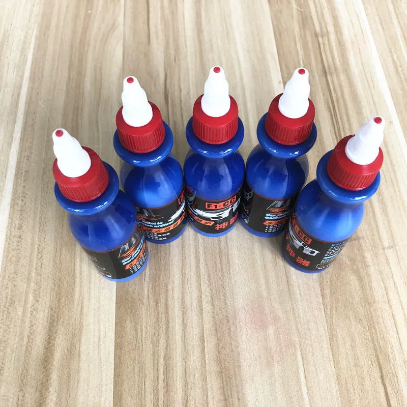 Small blue car scratch repair applicator tool with wiping sponge and repair agent bottle
