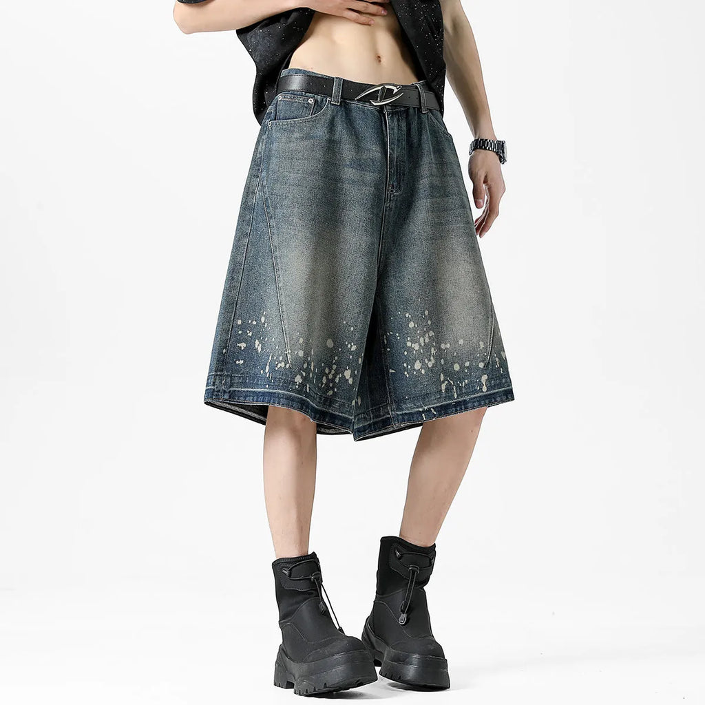 Men's retro blue denim shorts with ripped detailing and splash ink patterns on straight leg cut