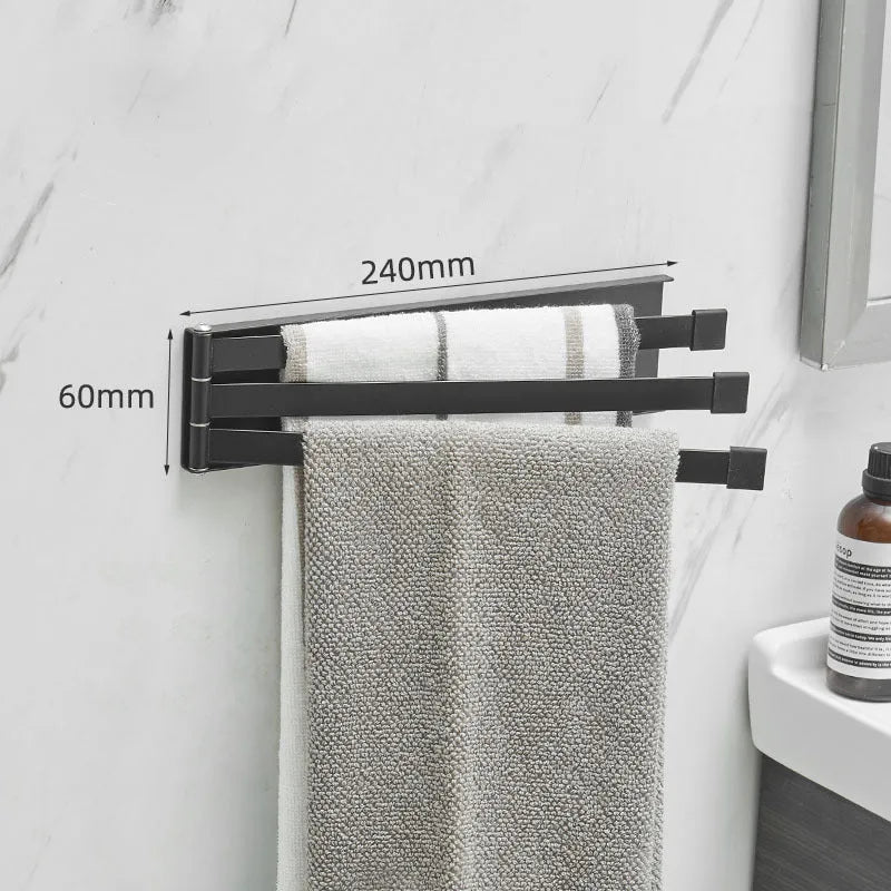 Black folding towel bar mounted on a bathroom wall with adhesive, shown in extended and folded positions.